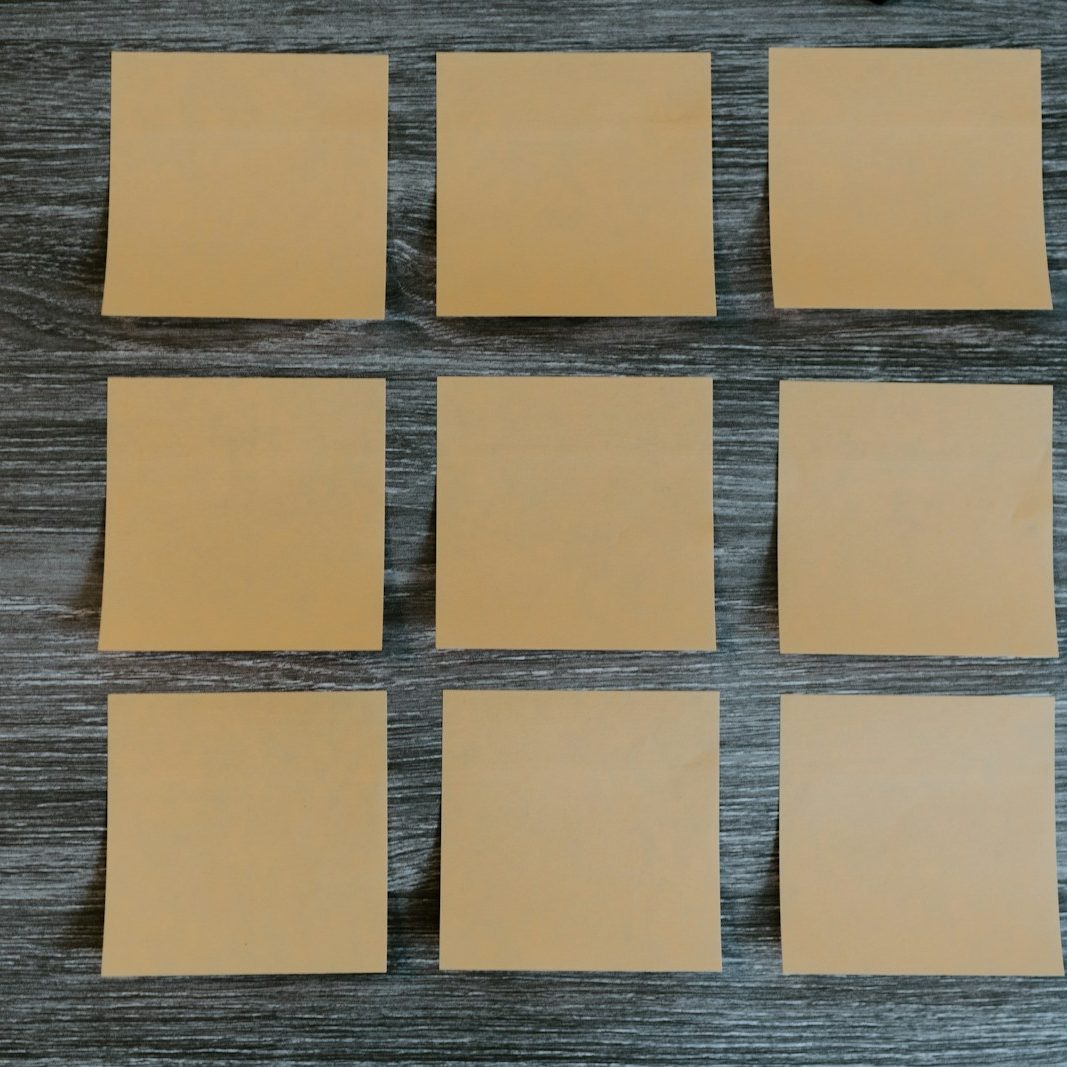 yellow sticky notes on brown wooden table